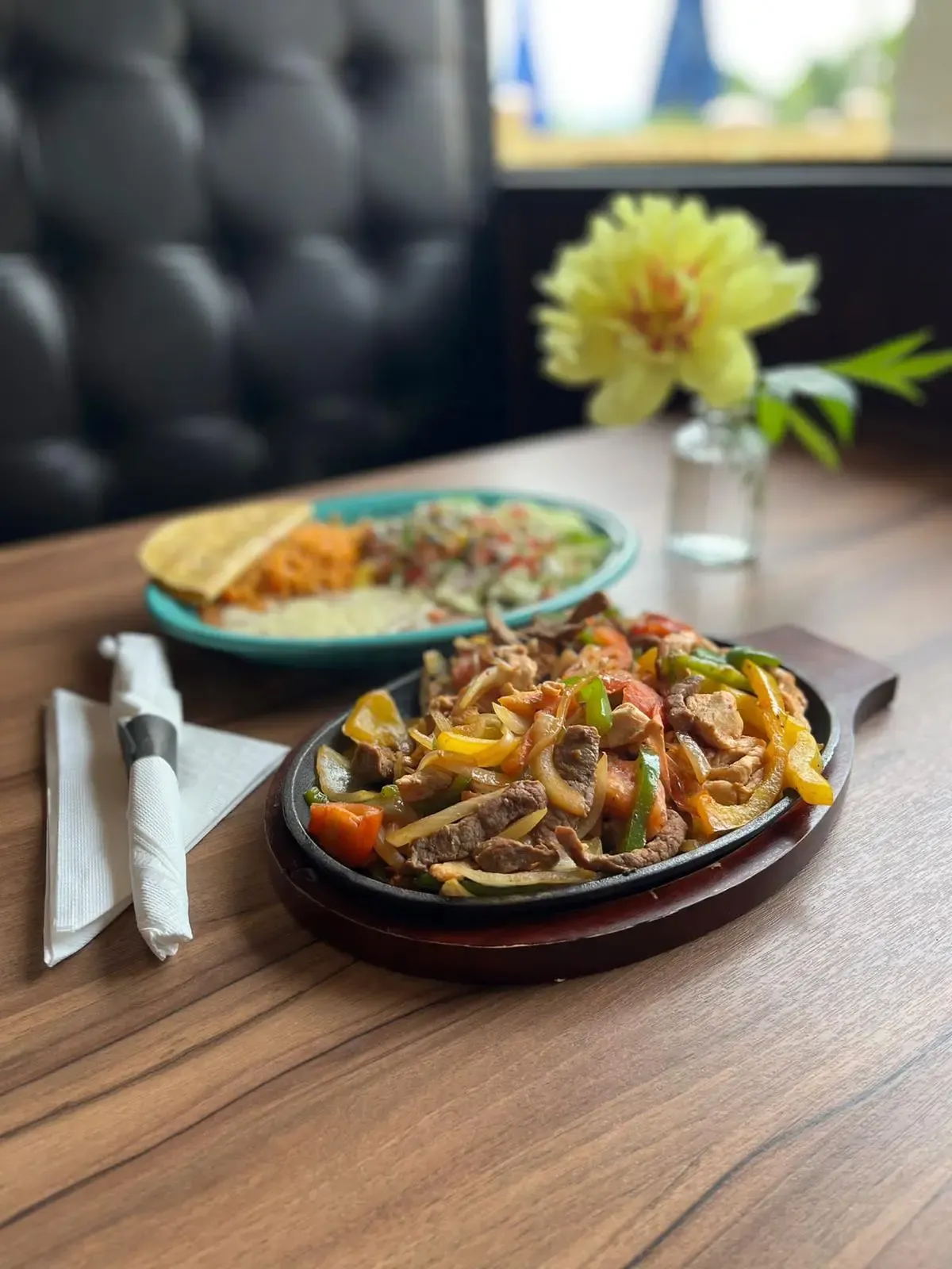 Sizzling chicken fajitas served on a hot cast iron plate with peppers and onions at Casa Real Mexican Restaurant